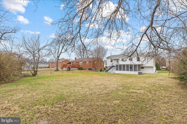 a yellow house in middle of the forest