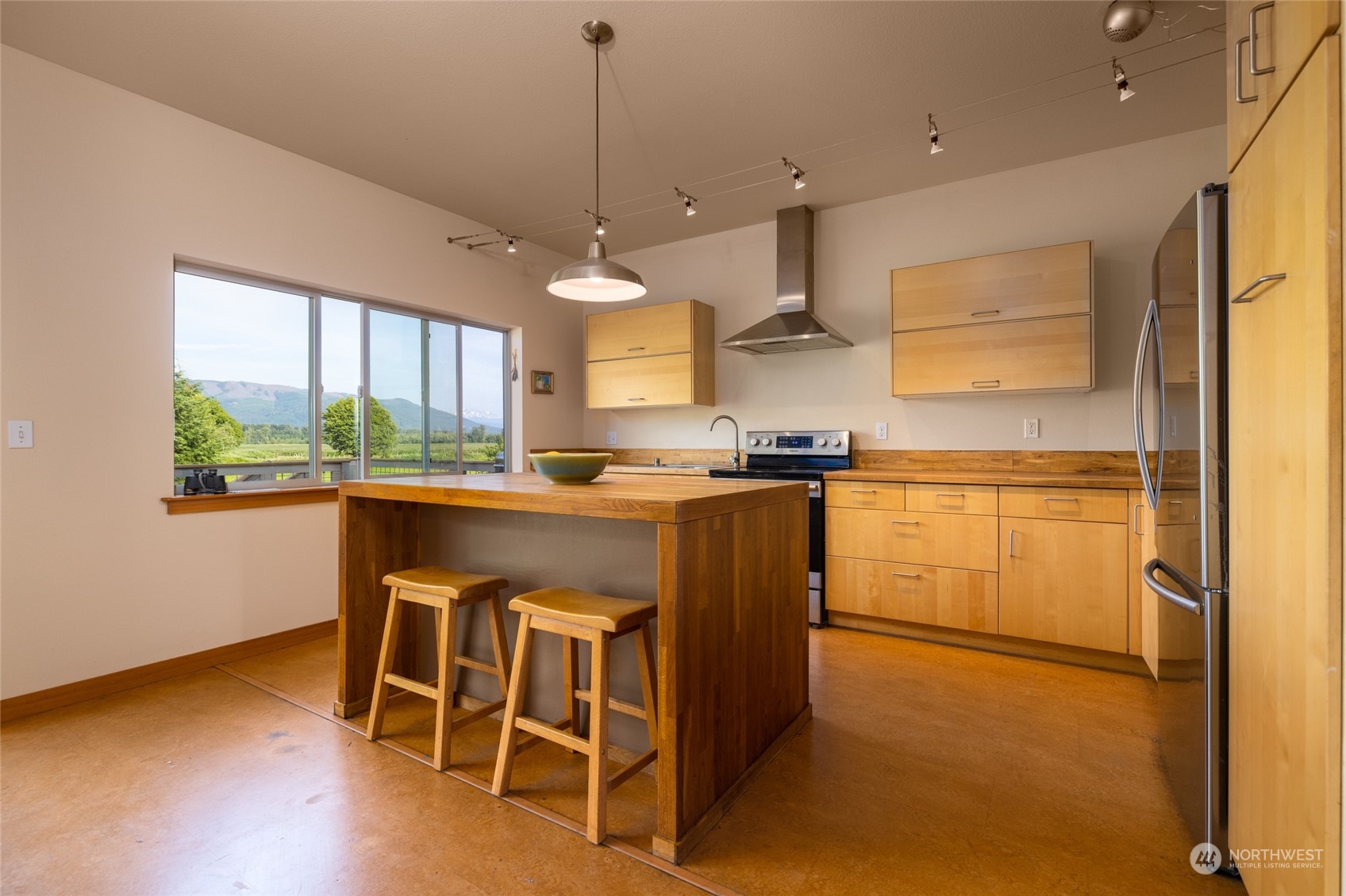 908 Mission Road Everson, WA 98247 - Photo 16 of 40 a kitchen with kitchen island a stove a table and chairs in it