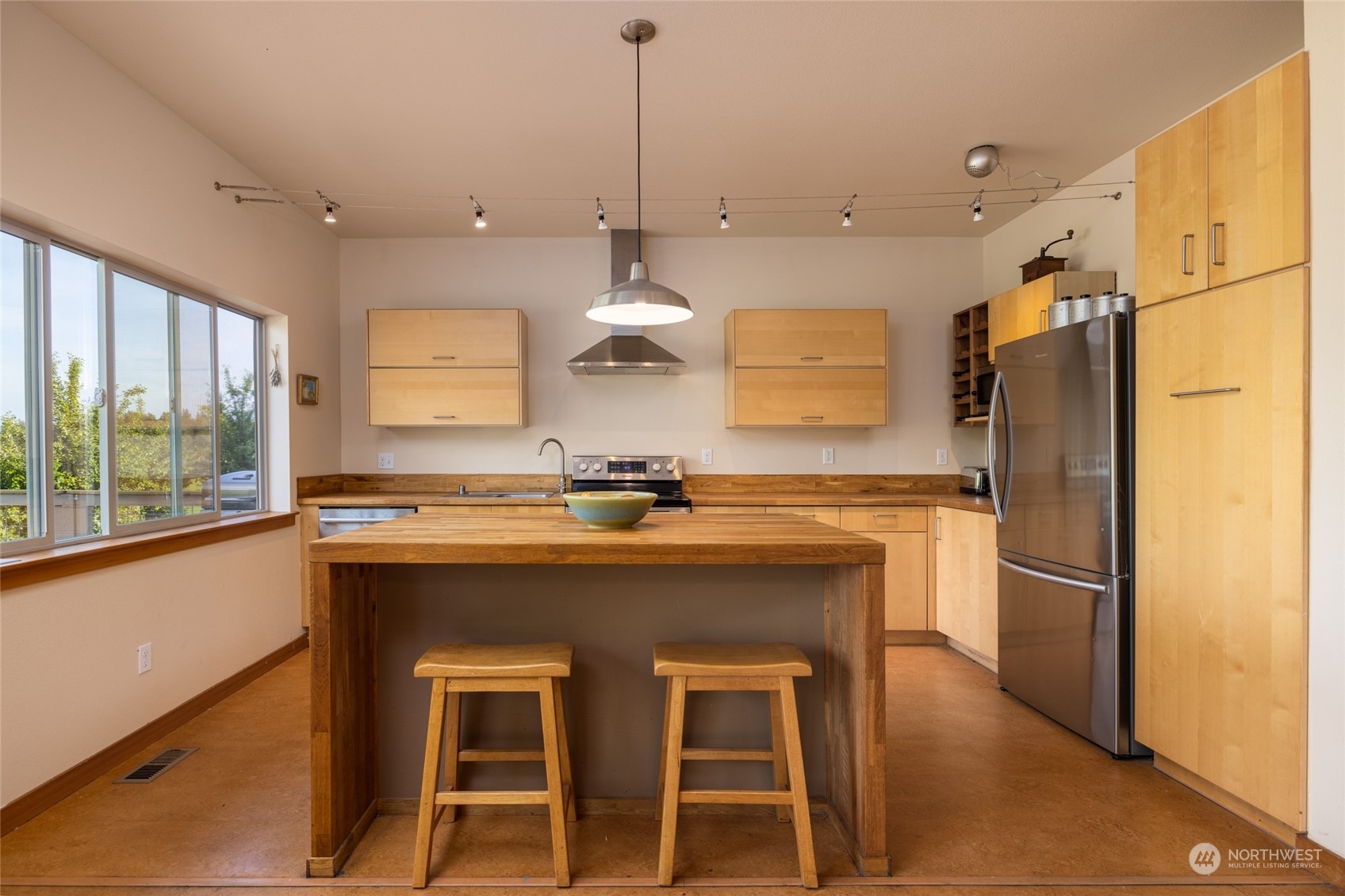 908 Mission Road Everson, WA 98247 - Photo 17 of 40 a kitchen with refrigerator cabinets and large window