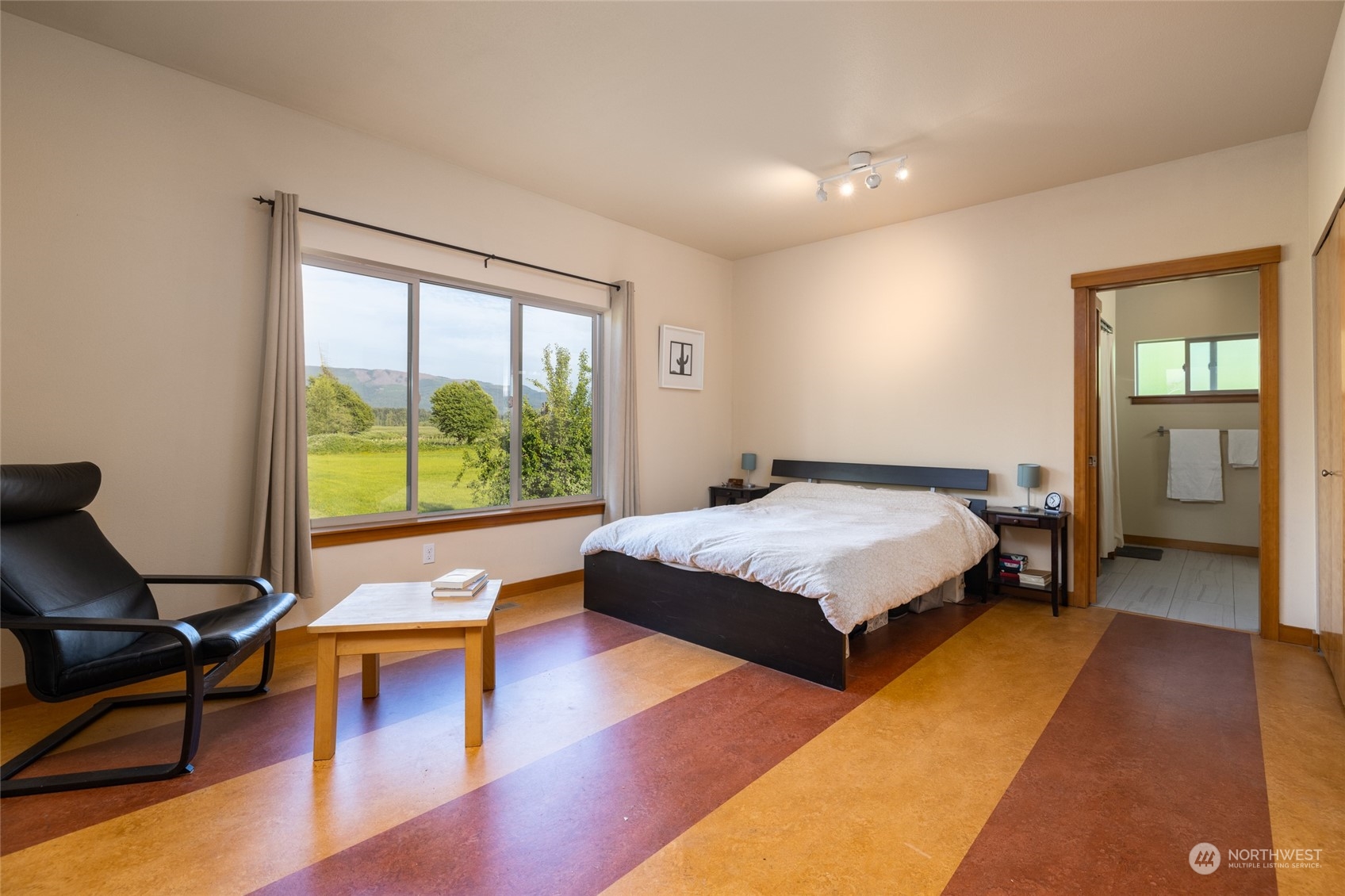 908 Mission Road Everson, WA 98247 - Photo 24 of 40 a spacious bedroom with a bed and large windows