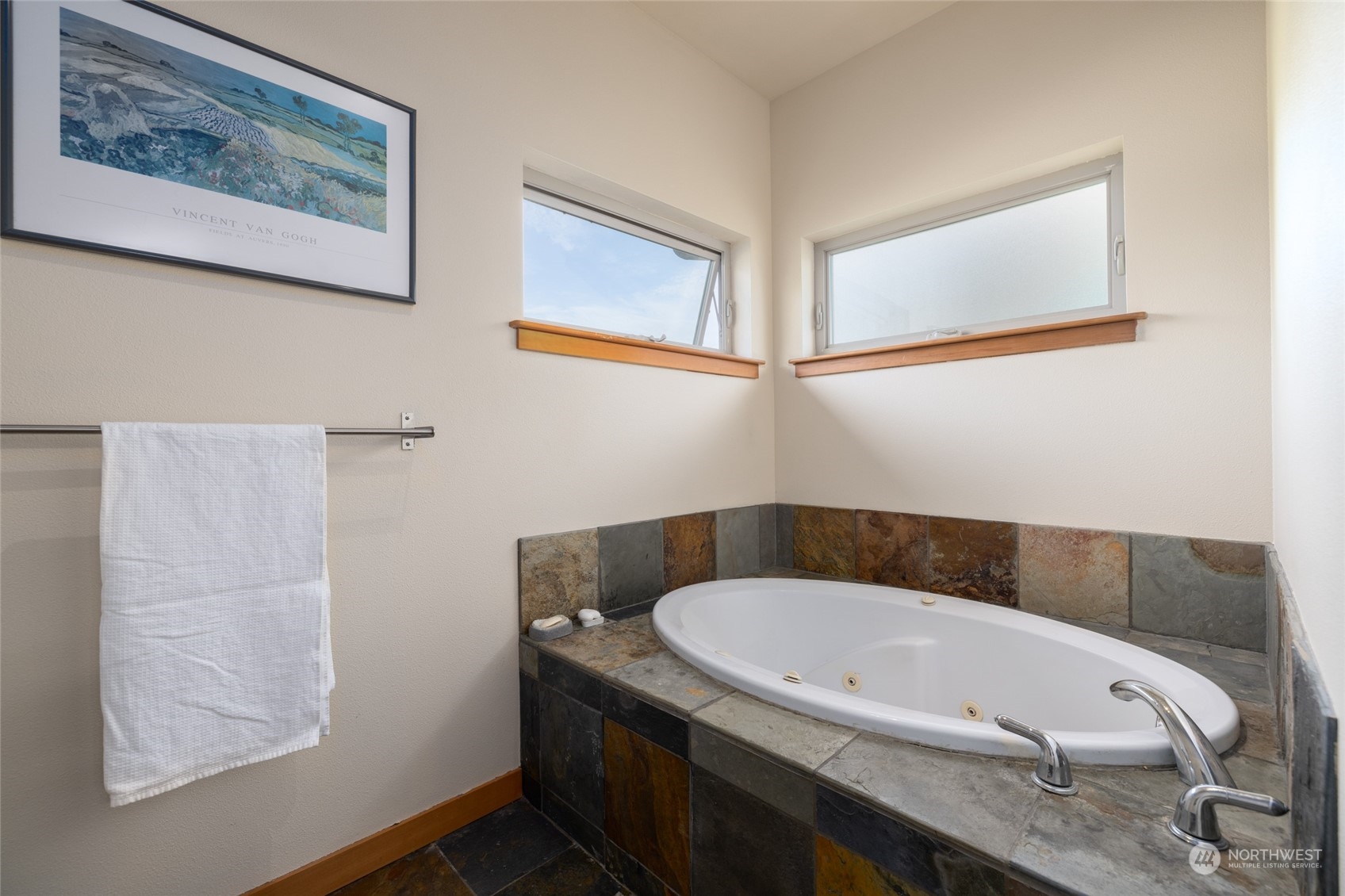 908 Mission Road Everson, WA 98247 - Photo 26 of 40 a bathroom with a tub and a painting on the wall