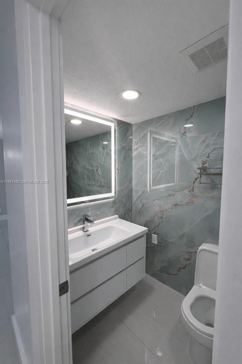 6901 Cypress Road, Unit B17 Plantation, FL 33317 - Photo 11 of 11 a bathroom with a sink a toilet and shower