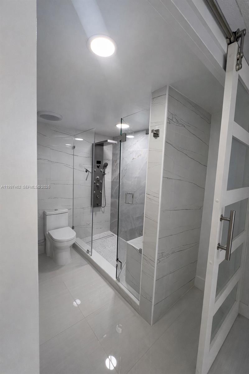 6901 Cypress Road, Unit B17 Plantation, FL 33317 - Photo 8 of 11 a bathroom with a shower and toilet