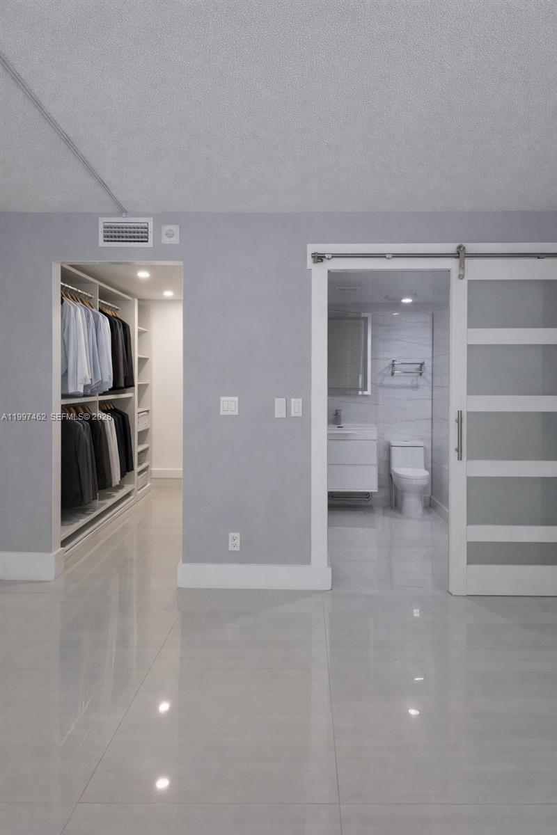 6901 Cypress Road, Unit B17 Plantation, FL 33317 - Photo 9 of 11 a view of a hallway with wooden shelves