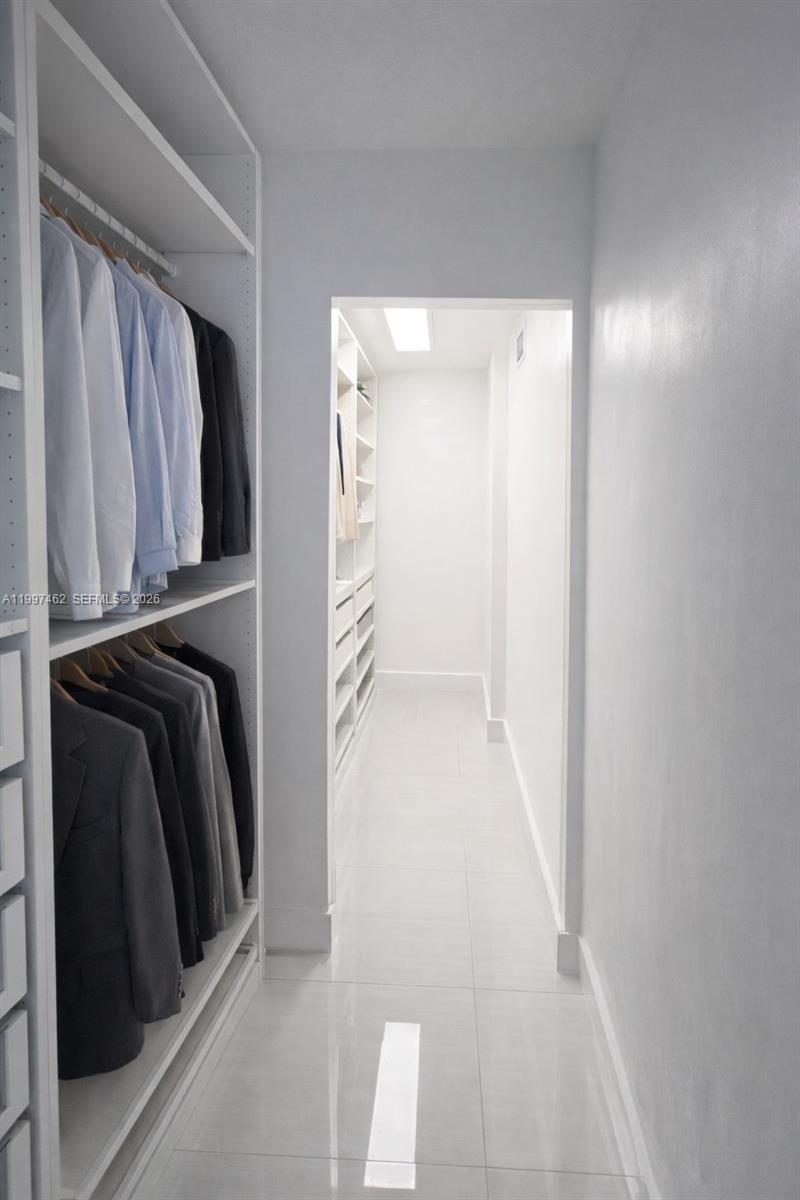 6901 Cypress Road, Unit B17 Plantation, FL 33317 - Photo 10 of 11 a view of walk in closet with clothes and shoes