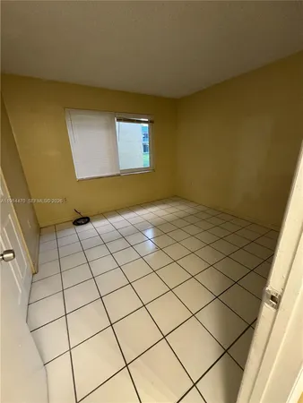 a view of an empty room and a window