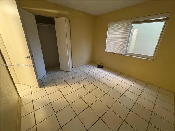 a view of an empty room and a window