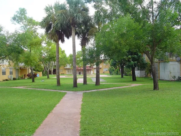 a view of a house with a wooden fence