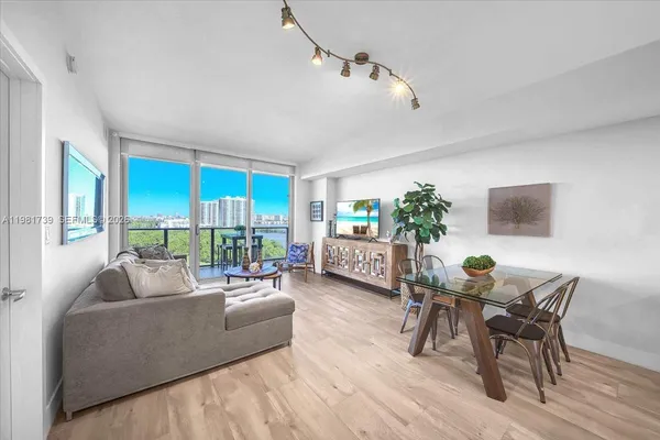 a living room with furniture and a wooden floor