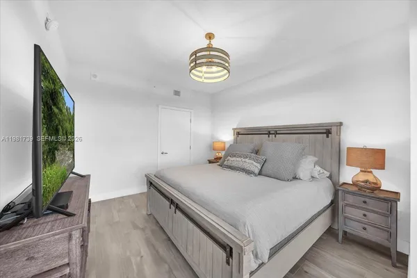a living room with furniture and a view of kitchen