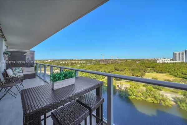 a view of a chairs and table on the balcony