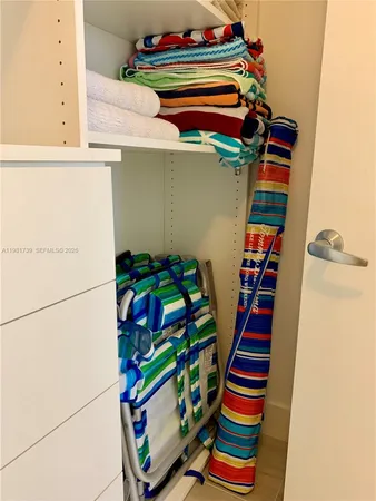 a view of a patio with table and chairs potted plants and palm trees