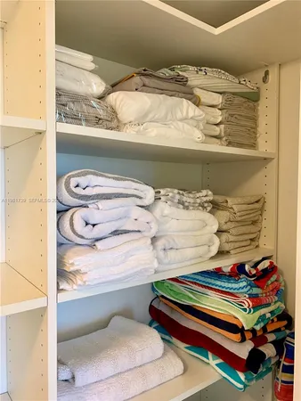 a view of backyard with lawn chairs plants and tree