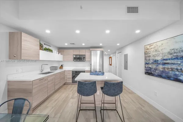 a view of a livingroom with furniture and floor to ceiling window