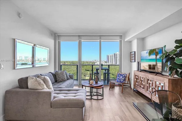 a bedroom with a bed and a large window with outer view