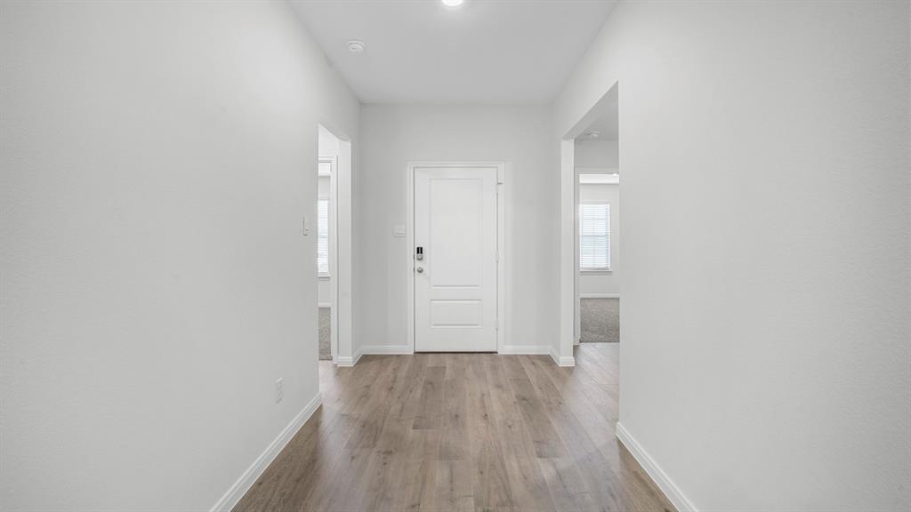 1921 Reveille Way Terrell, TX 75160 - Photo 11 of 30 a view of a hallway with wooden floor
