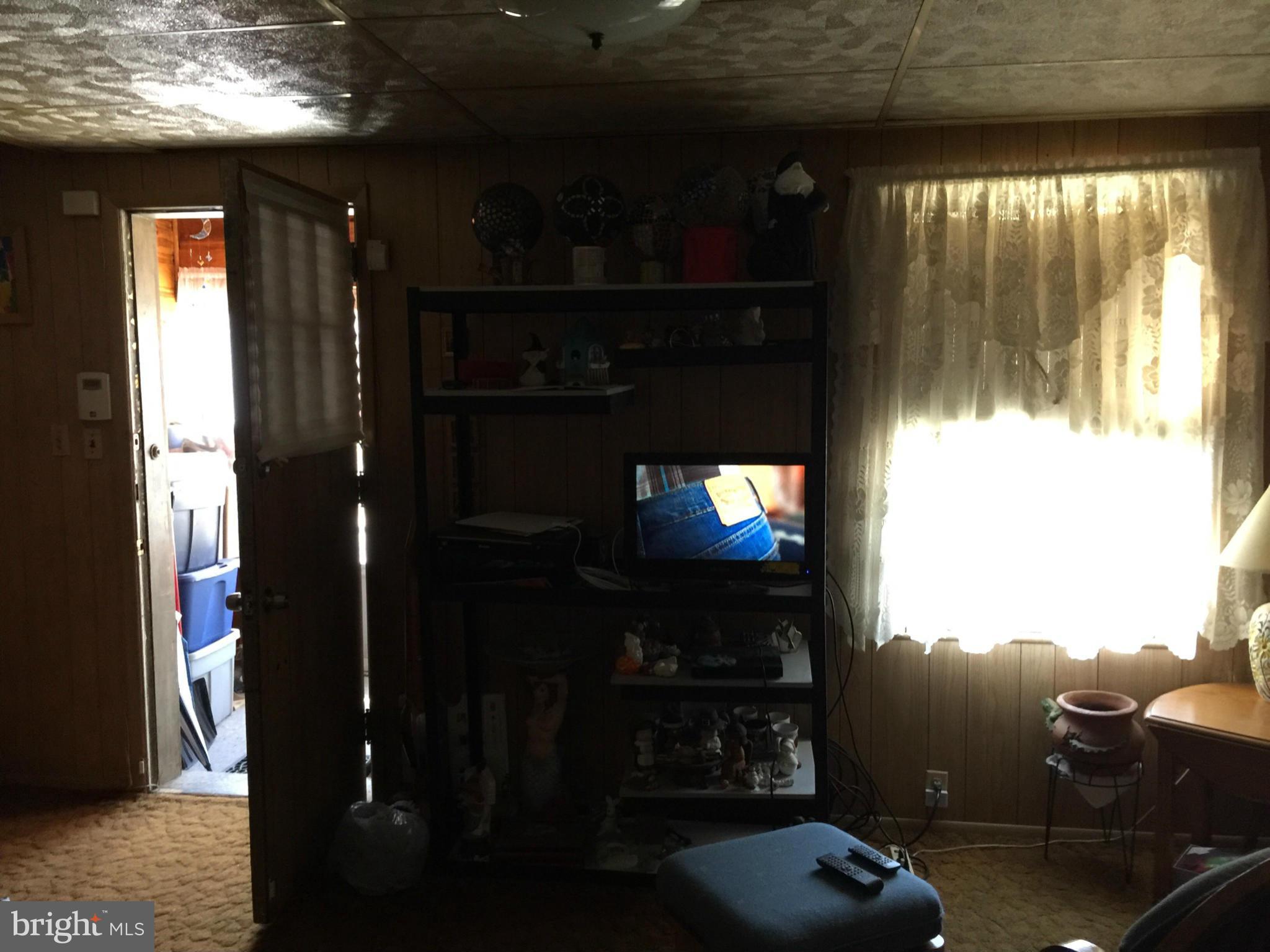 21 Portship Road Baltimore, MD 21222 - Photo 6 of 9 a living room with furniture and a flat screen tv