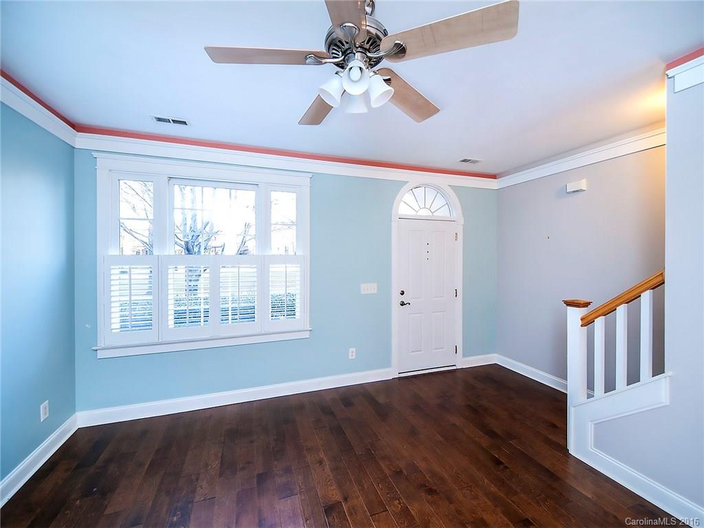 298 Elis Way, Unit 298 Fort Mill, SC 29708 - Photo 2 of 19 a view of an empty room with wooden floor and a window