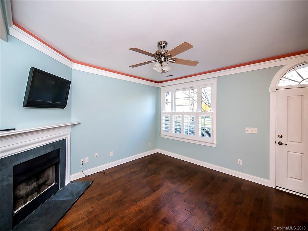 298 Elis Way, Unit 298 Fort Mill, SC 29708 - Photo 3 of 19 a living room with a fireplace and a flat screen tv
