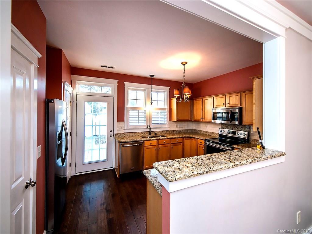 298 Elis Way, Unit 298 Fort Mill, SC 29708 - Photo 5 of 19 a kitchen with stainless steel appliances granite countertop sink stove and refrigerator