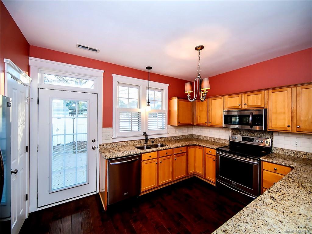 298 Elis Way, Unit 298 Fort Mill, SC 29708 - Photo 6 of 19 a kitchen with stainless steel appliances granite countertop a sink a stove and a refrigerator