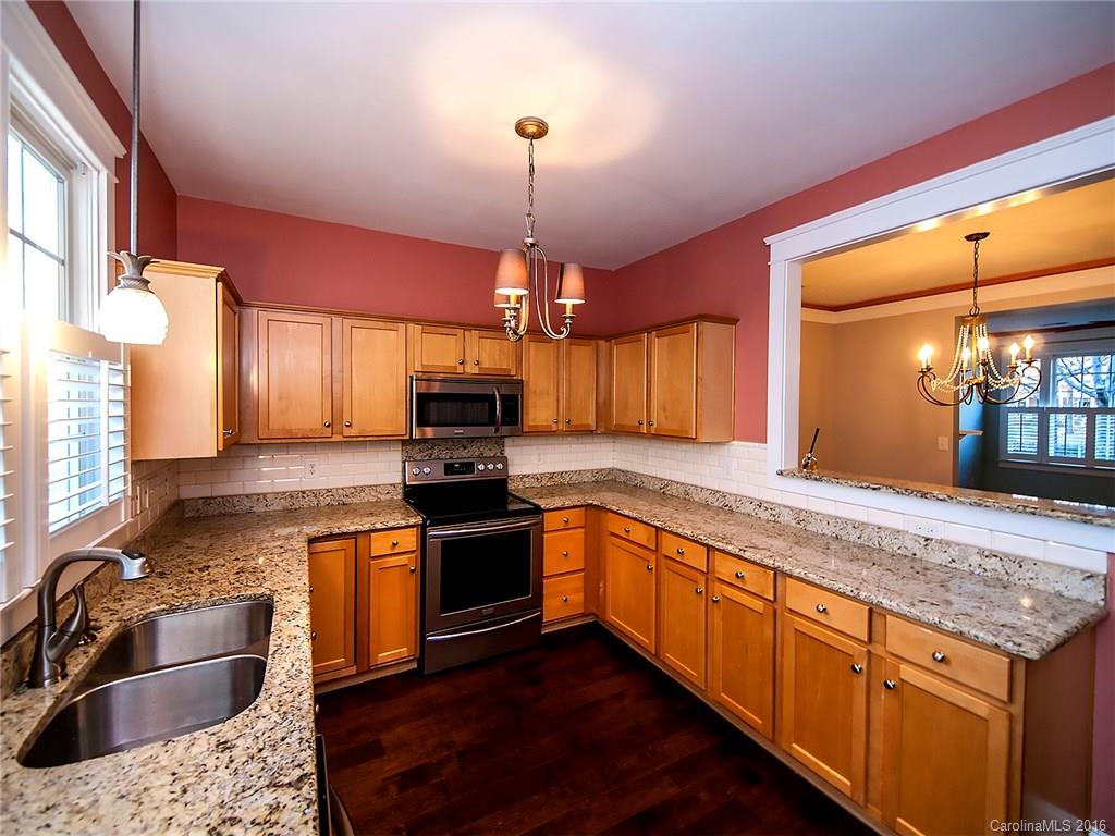 298 Elis Way, Unit 298 Fort Mill, SC 29708 - Photo 7 of 19 a kitchen with stainless steel appliances granite countertop a sink stove and refrigerator