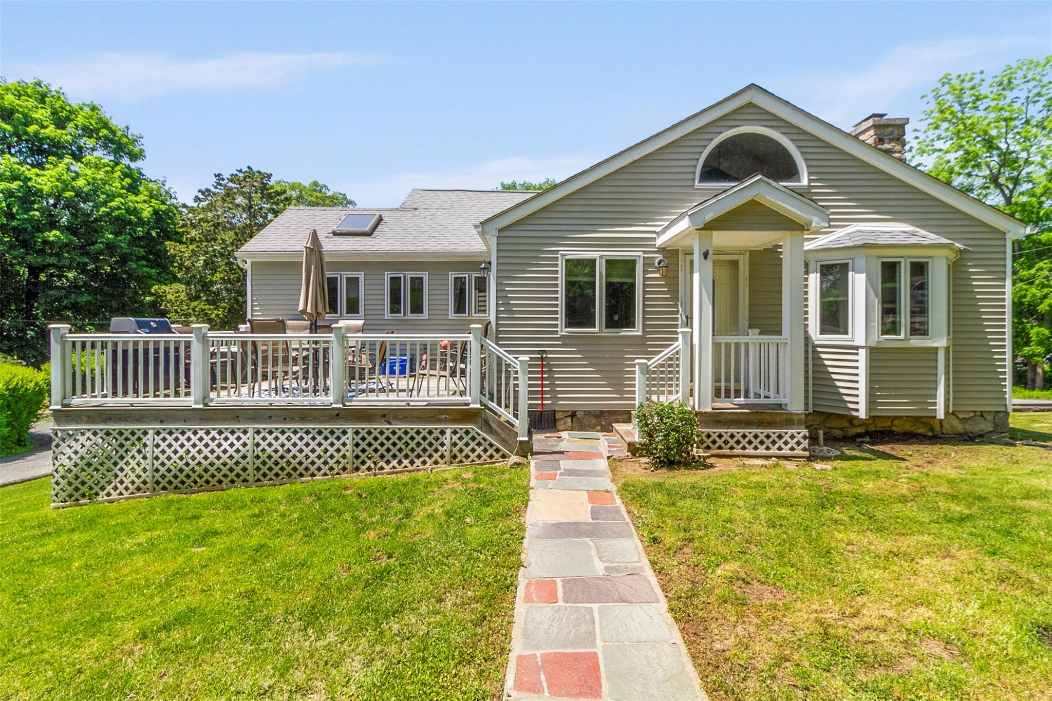 a front view of a house with a garden