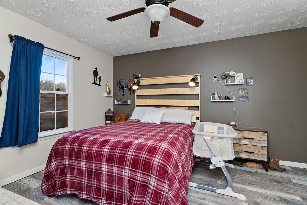 149 China Clay Road Stuarts Draft, VA 24477 - Photo 11 of 22 a bedroom with a bed and wooden floor