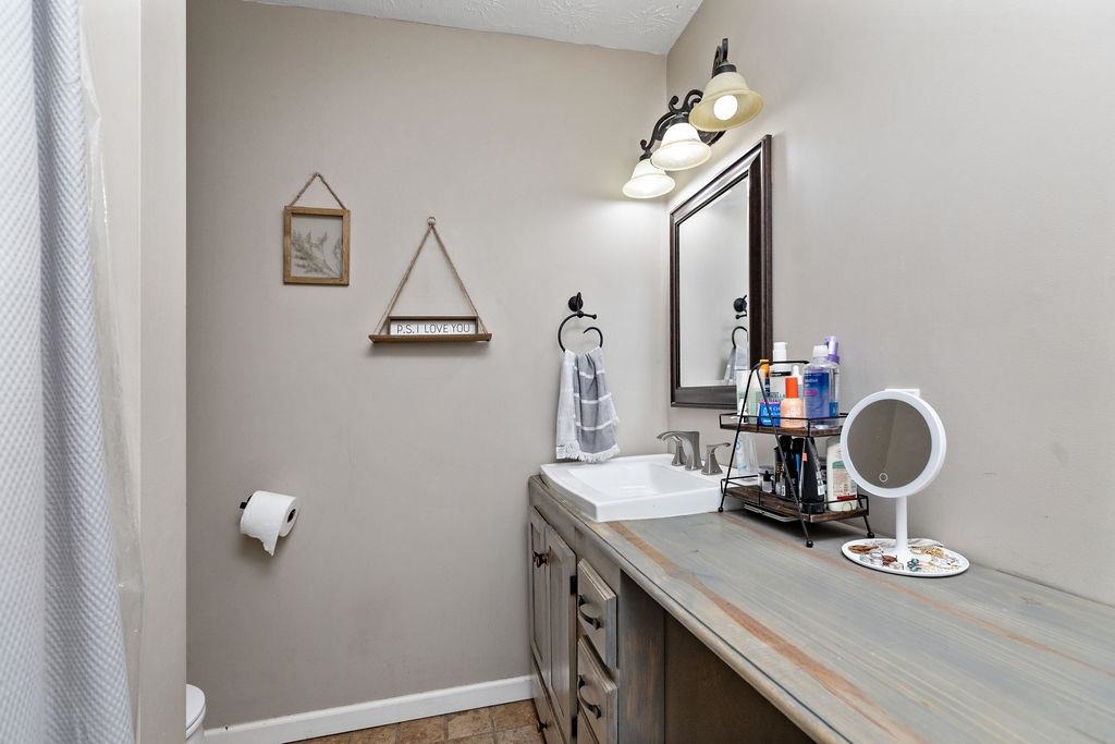 149 China Clay Road Stuarts Draft, VA 24477 - Photo 13 of 22 a bathroom with a sink a mirror and vanity