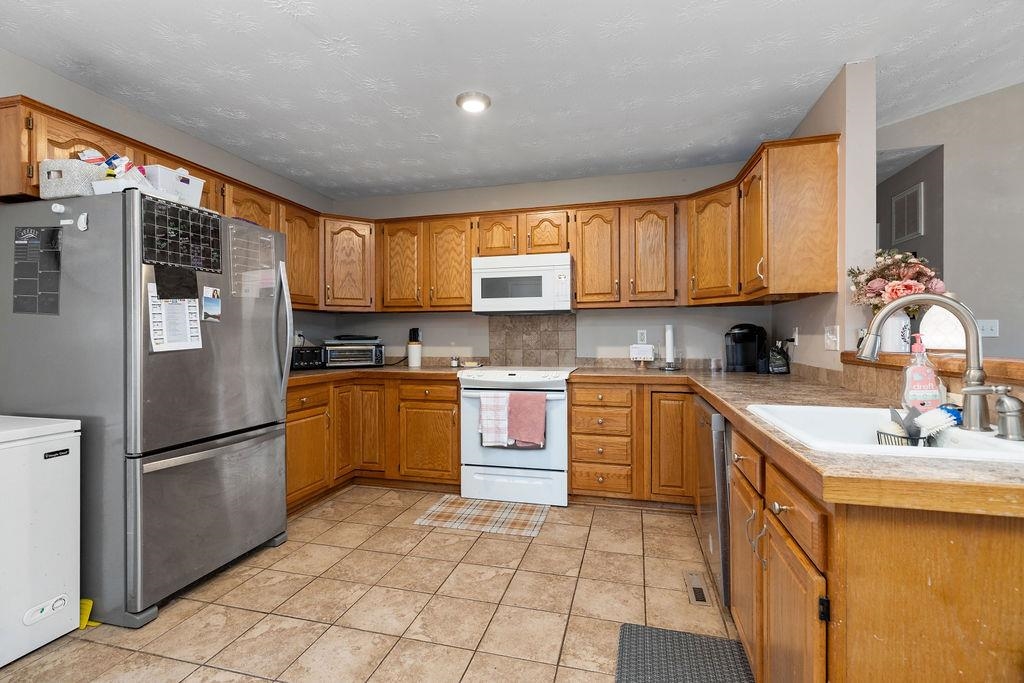 149 China Clay Road Stuarts Draft, VA 24477 - Photo 7 of 22 a kitchen with a refrigerator sink and cabinets