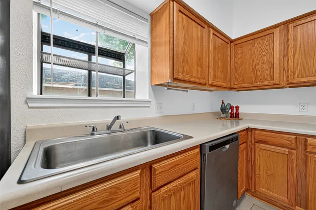 a kitchen with stainless steel appliances granite countertop a sink and a cabinets