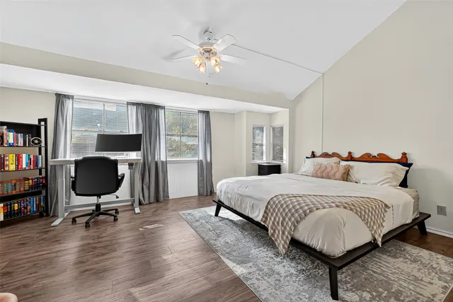 a bedroom with a bed workspace and a window