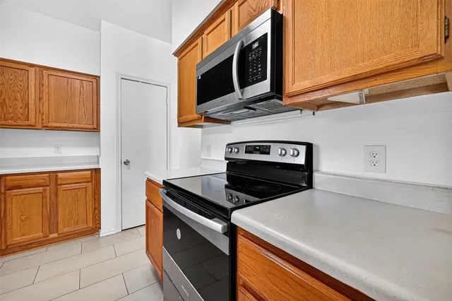 a kitchen with stainless steel appliances granite countertop a stove and a microwave