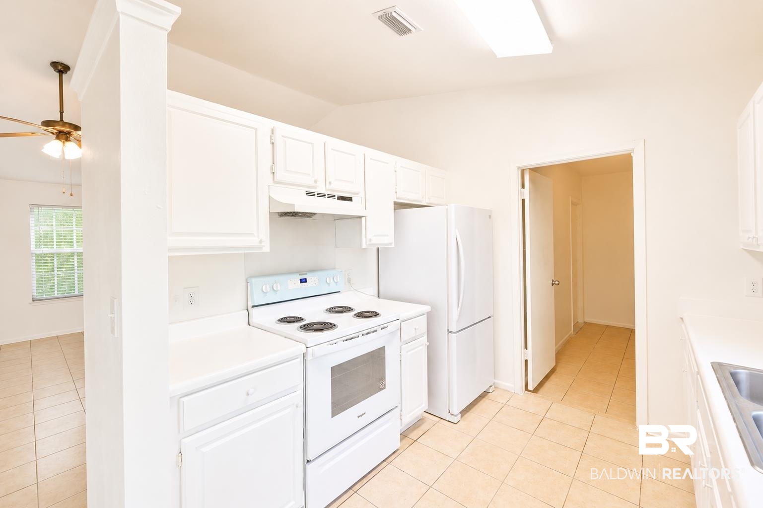 614 East Gate Circle Foley, AL 36535 - Photo 11 of 31 Kitchen featuring white cabinetry, solid surface countertops, white range, and a white refrigerator