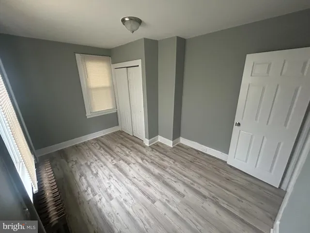 a view of room with window and wooden floor