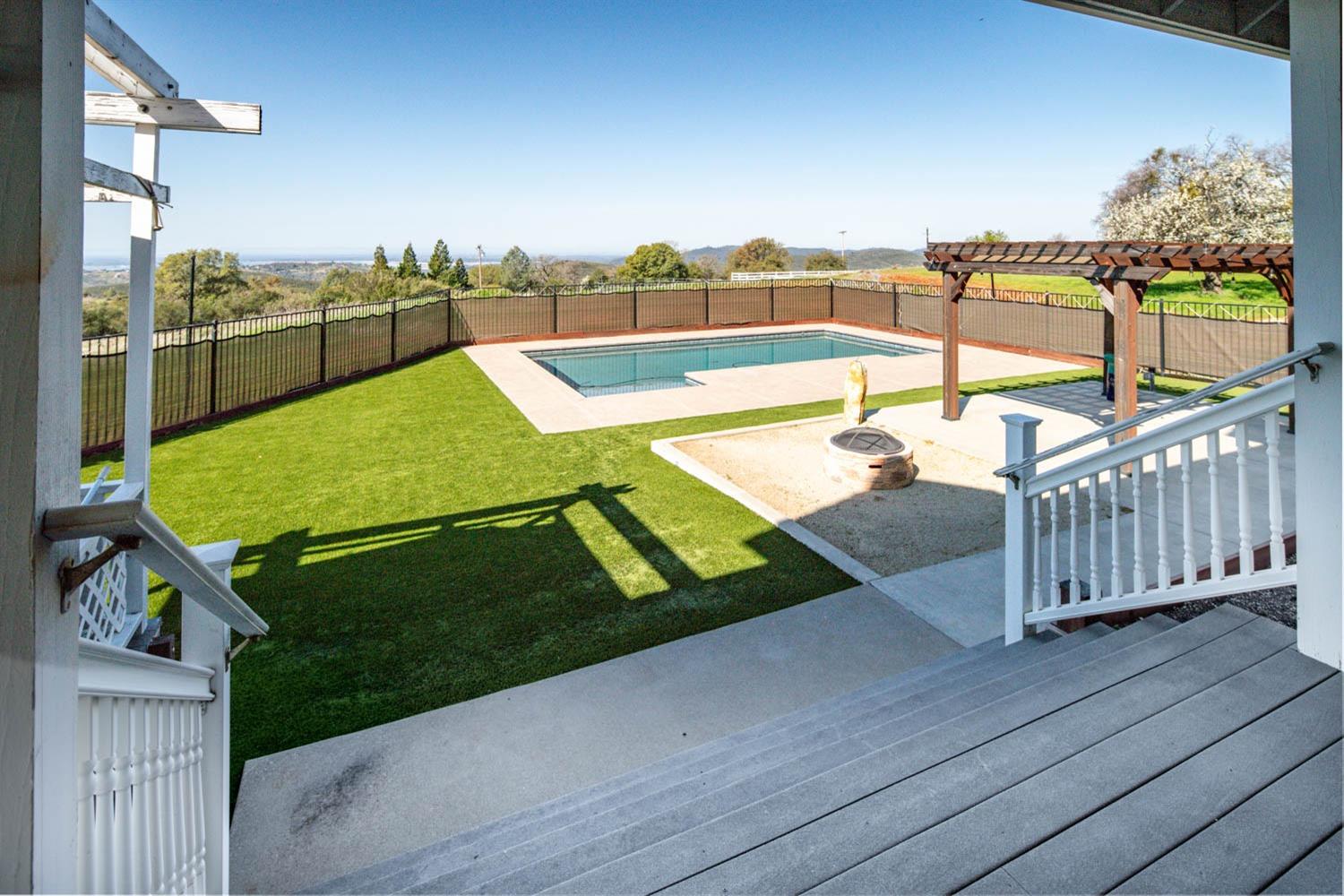 2661 Mountain Oak Lane Rescue, CA 95672 - Photo 32 of 88 Fully enclosed backyard with newer pebble tech pool, fire pit, pergola and hot tub near primary suite