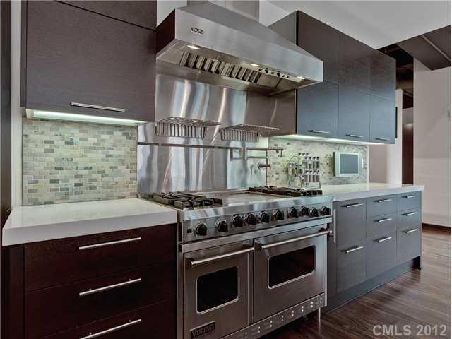 139 South Tryon Street, Unit 3B Charlotte, NC 28202 - Photo 2 of 16 a kitchen with stainless steel appliances granite countertop a stove and a microwave