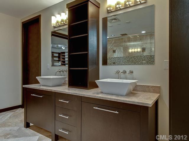 139 South Tryon Street, Unit 3B Charlotte, NC 28202 - Photo 12 of 16 a bathroom with a sink and a mirror