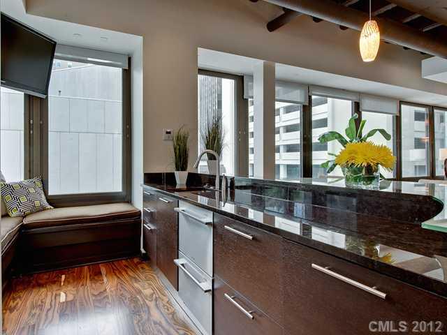 139 South Tryon Street, Unit 3B Charlotte, NC 28202 - Photo 6 of 16 a living room with granite countertop kitchen furniture and a potted plant