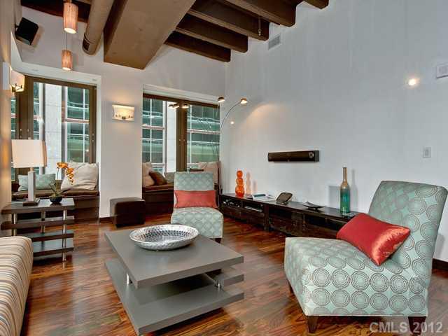 139 South Tryon Street, Unit 3B Charlotte, NC 28202 - Photo 8 of 16 a living room with furniture and a large window