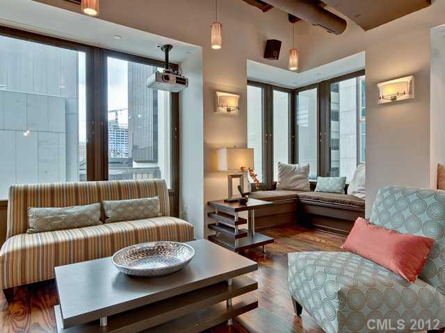 139 South Tryon Street, Unit 3B Charlotte, NC 28202 - Photo 9 of 16 a living room with furniture and a large window