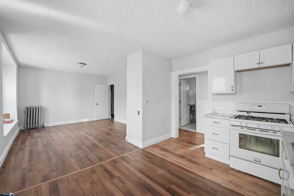a view of a kitchen with a stove cabinets and wooden floor