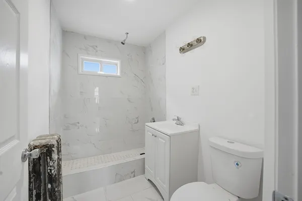 a bathroom with a toilet a sink and bathtub