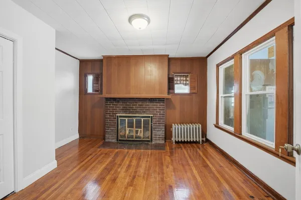 a view of livingroom with hardwood floor and a fireplace