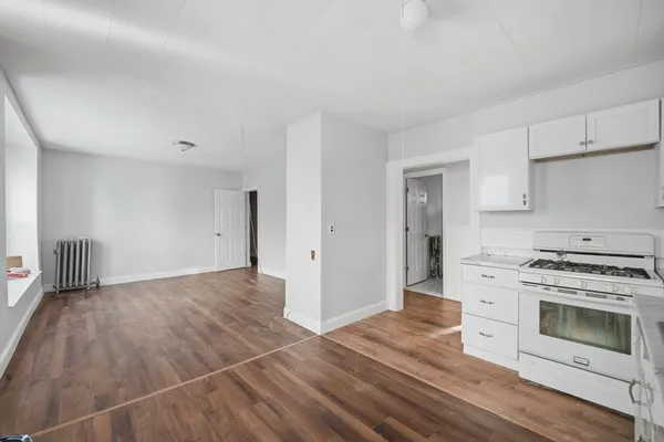 a view of a kitchen with a stove cabinets and wooden floor