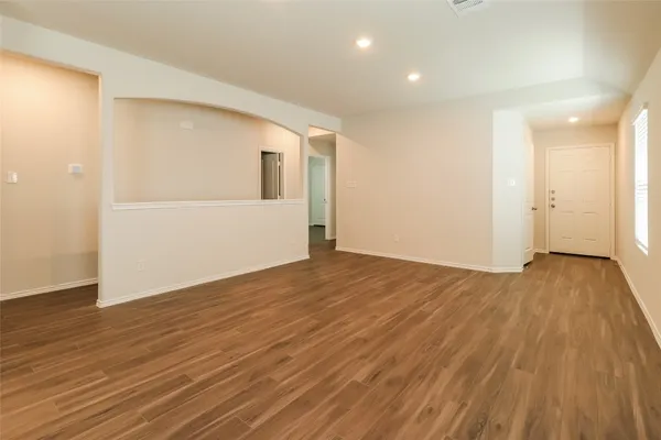 a view of a room with wooden floor and doors