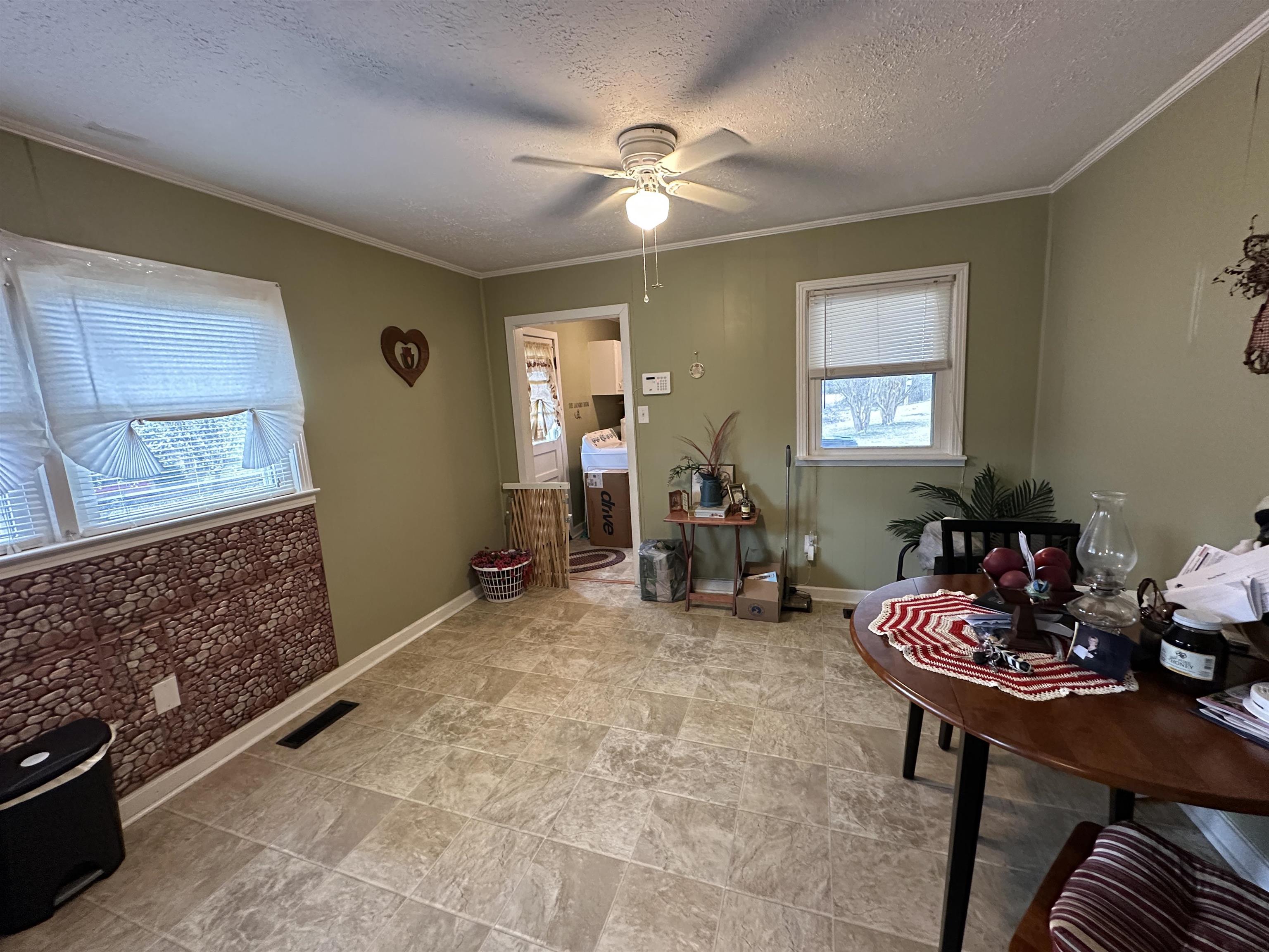 92 Puron Road Adamsville, TN 38310 - Photo 11 of 23 a living room with furniture and a chandelier