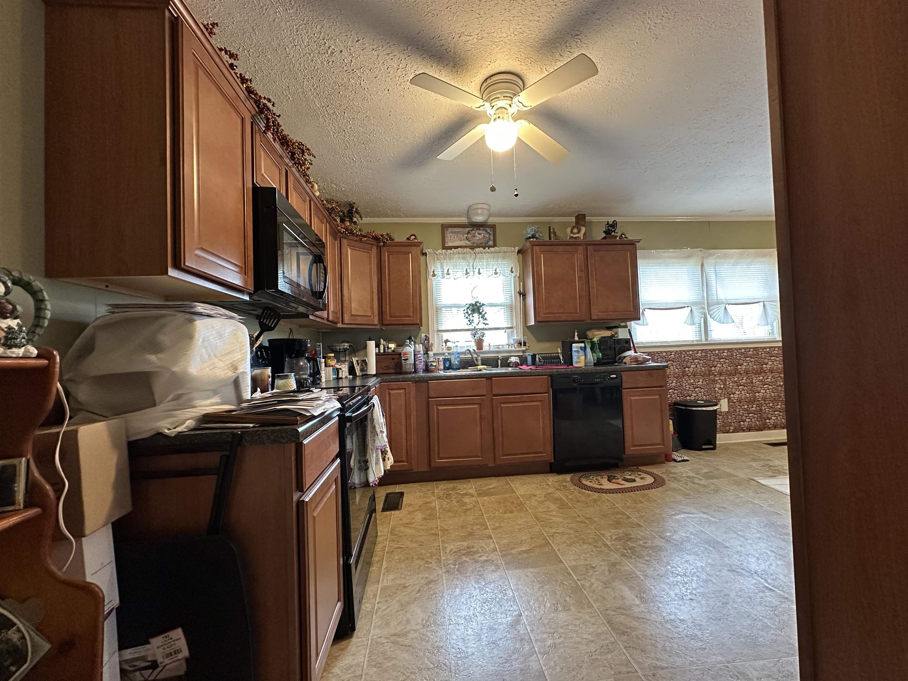92 Puron Road Adamsville, TN 38310 - Photo 14 of 23 a kitchen with stainless steel appliances granite countertop a stove sink and cabinets