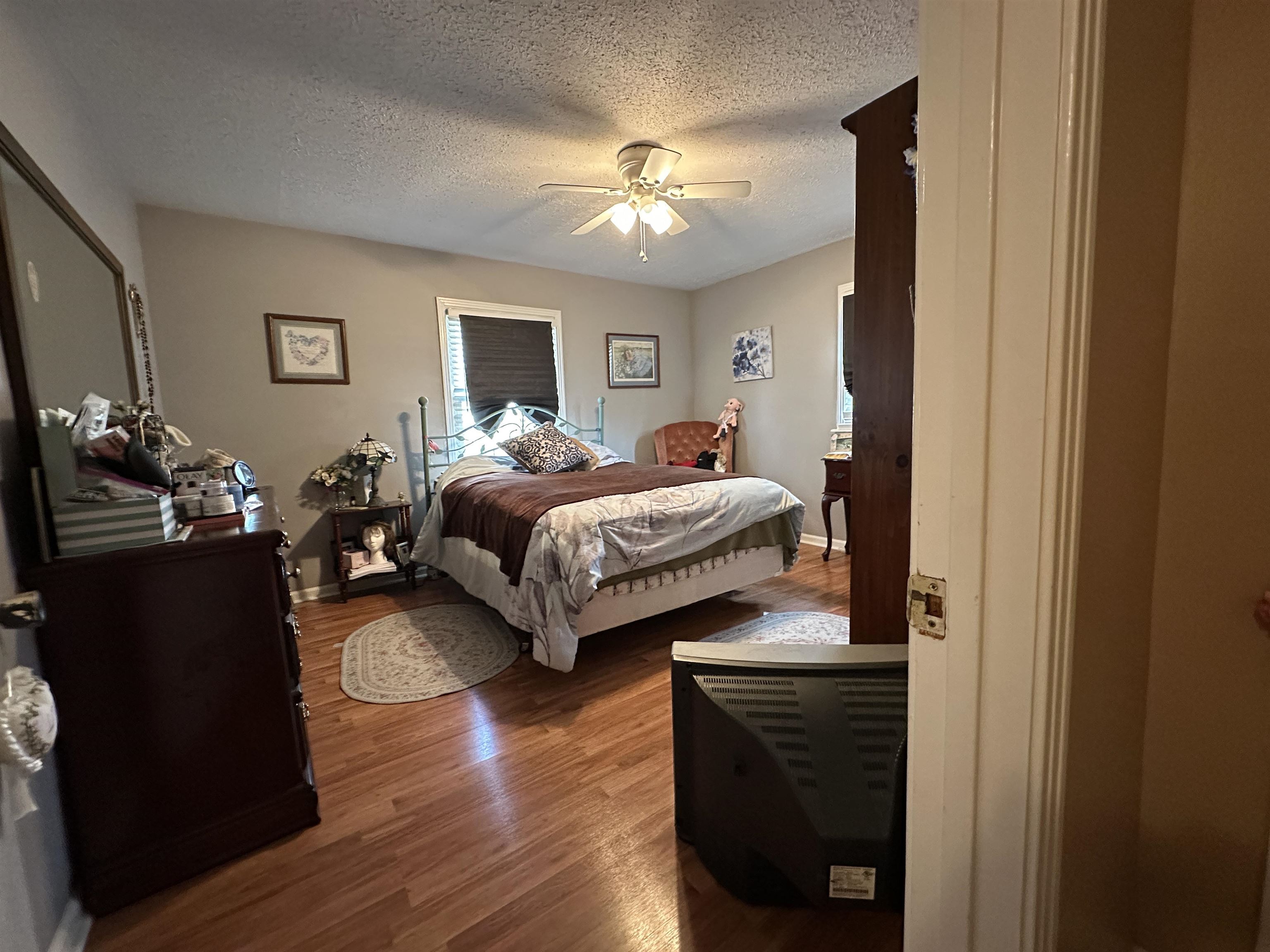 92 Puron Road Adamsville, TN 38310 - Photo 17 of 23 a bedroom with bed and a chandelier