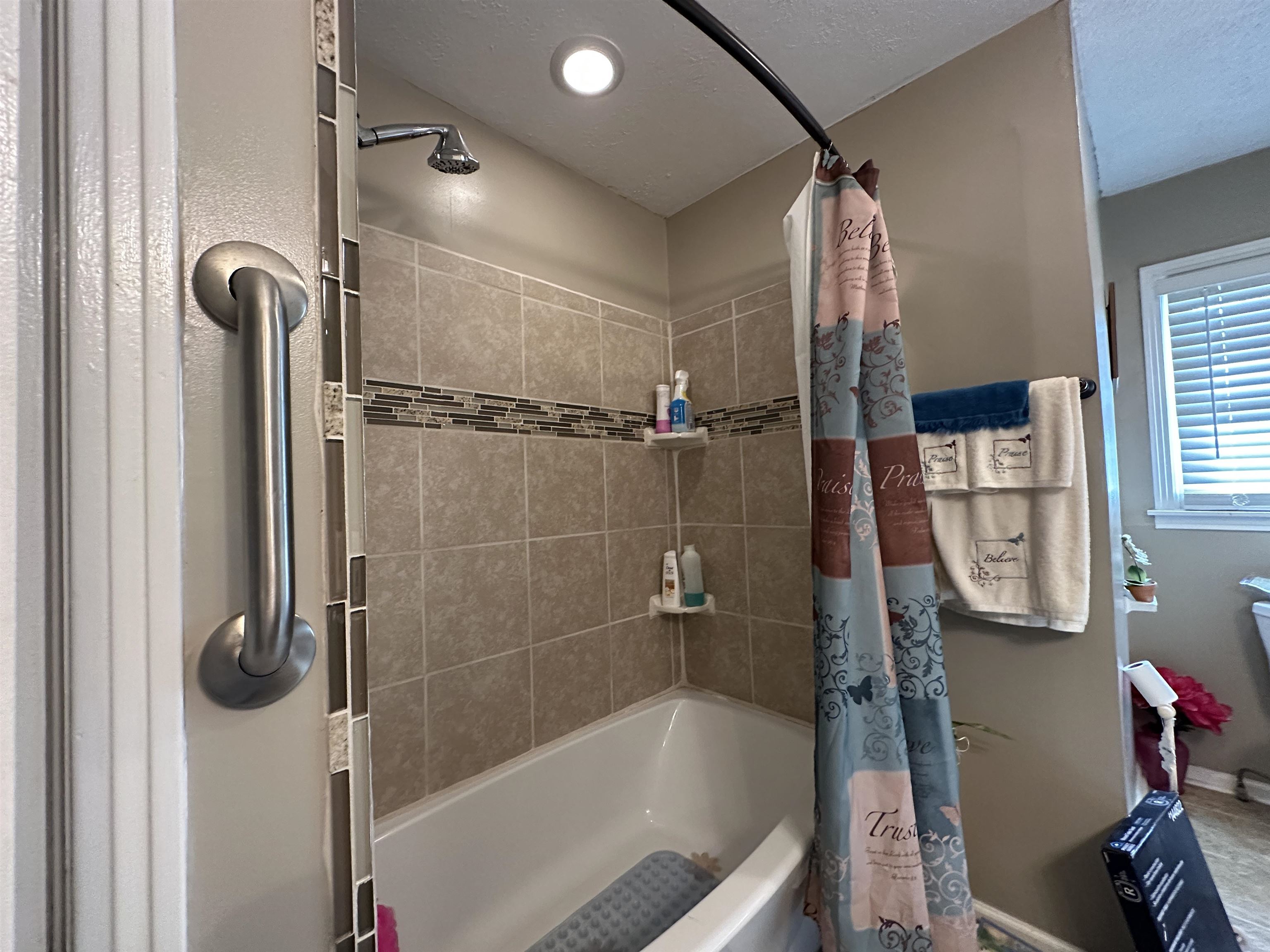 92 Puron Road Adamsville, TN 38310 - Photo 3 of 23 a bathroom with a shower and a tub